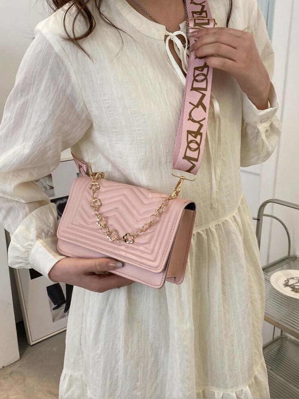 Pink Quilted Crossbody Bag with Chevron Pattern and Chain Detail